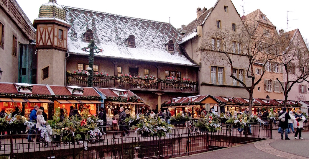 Beautiful restaurant in France with snow on the roof, decorated in Christmas lights and wreaths